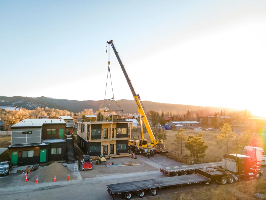 Crane setting a module on set day at Westgroup employee housing in Victor, Idaho
