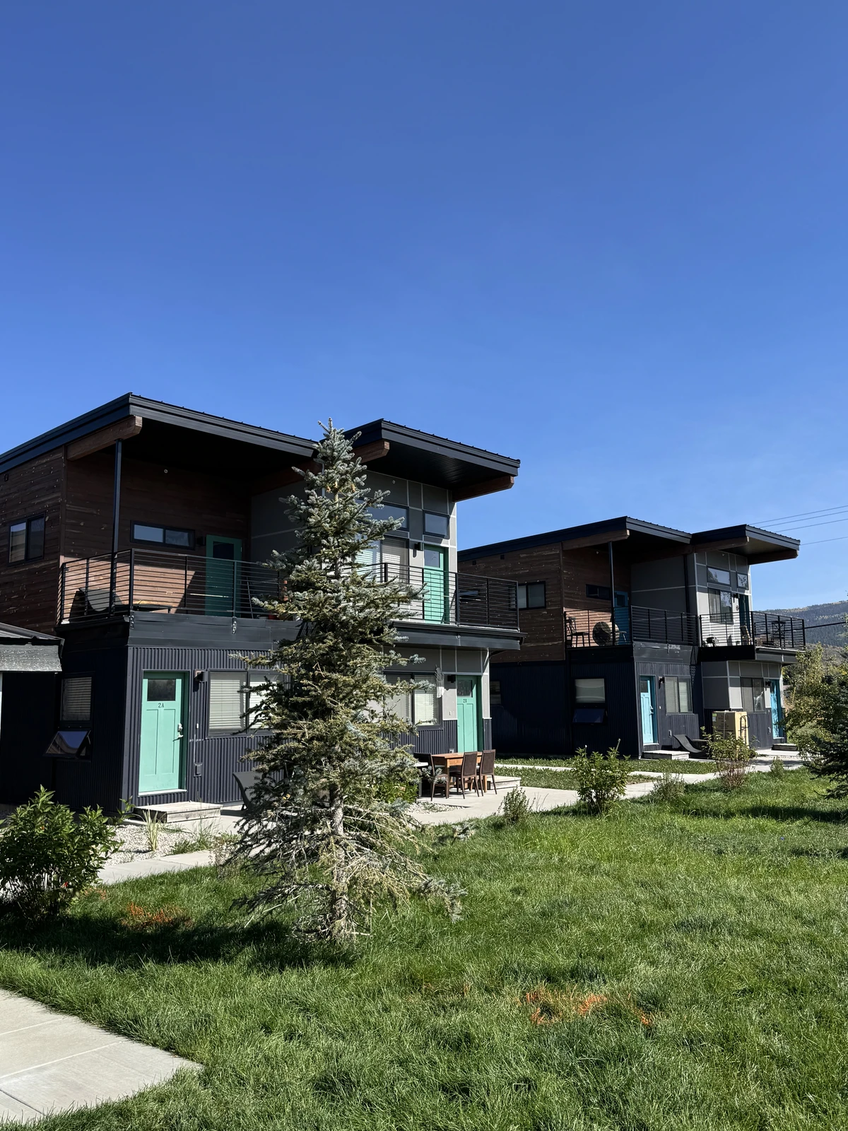 Finished two-story Westley buildings with teal doors at Westgroup employee housing in Victor, Idaho