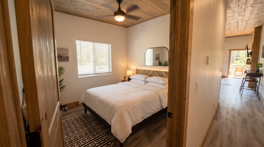Bedroom with white bedding in a modular rental at Island Park, Idaho