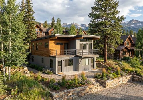 Contemporary mountain home built with prefab techniques in scenic forest setting.