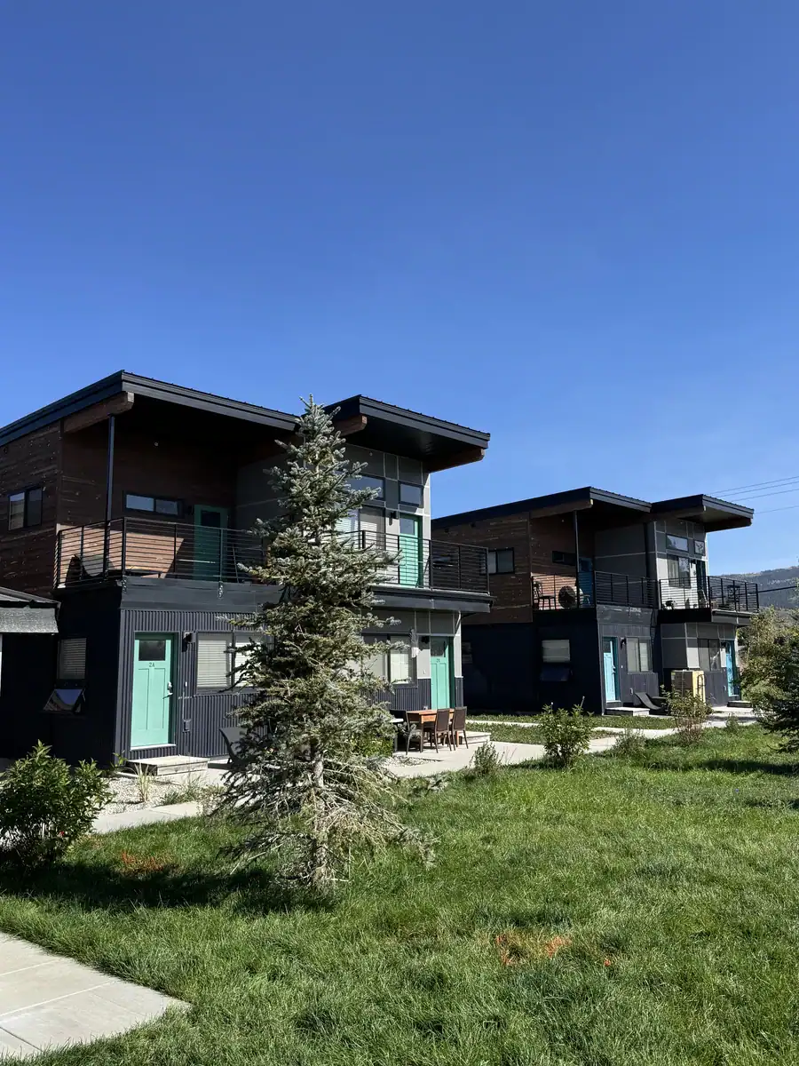 Finished two-story Westley buildings with teal doors at Westgroup employee housing in Victor, Idaho